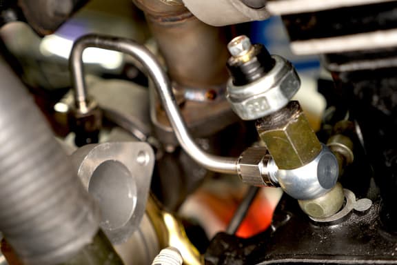 Stainless steel -4 AN hardline for turbo oil feed installed on turbo motorcycle